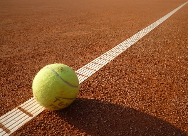 tennis ball one the court baseline