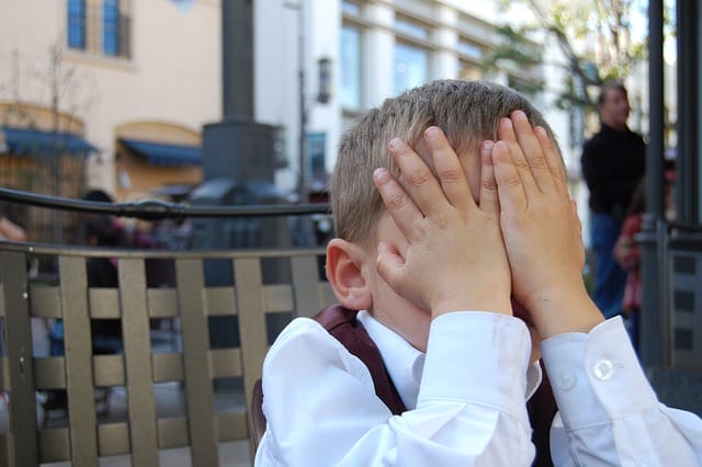 boy hiding face in hands