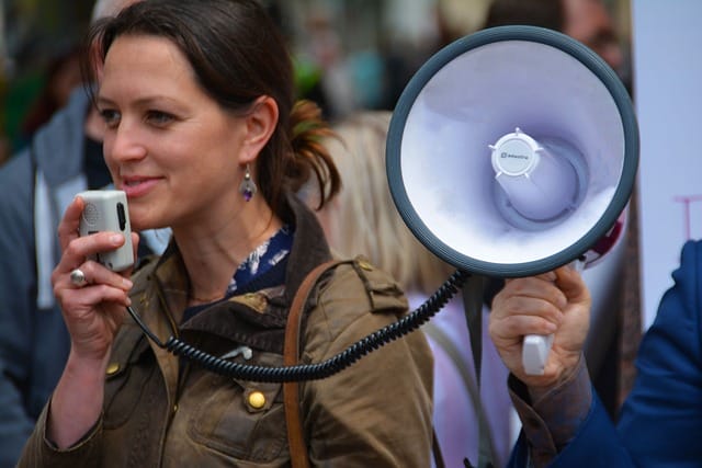 women speaking in public with a megaphone