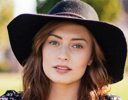 photo of assertive woman wearing hat