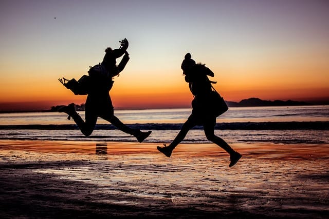 two people enjoying life by the sea